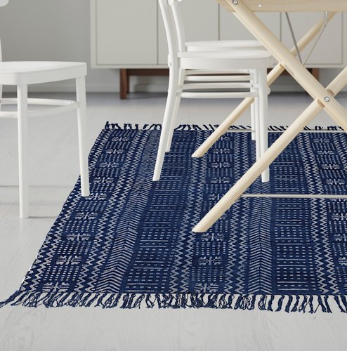 Blue dhurries rug under white dinning table